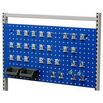 Tool board with hooks and storage drawers for organized overview in industrial work environment